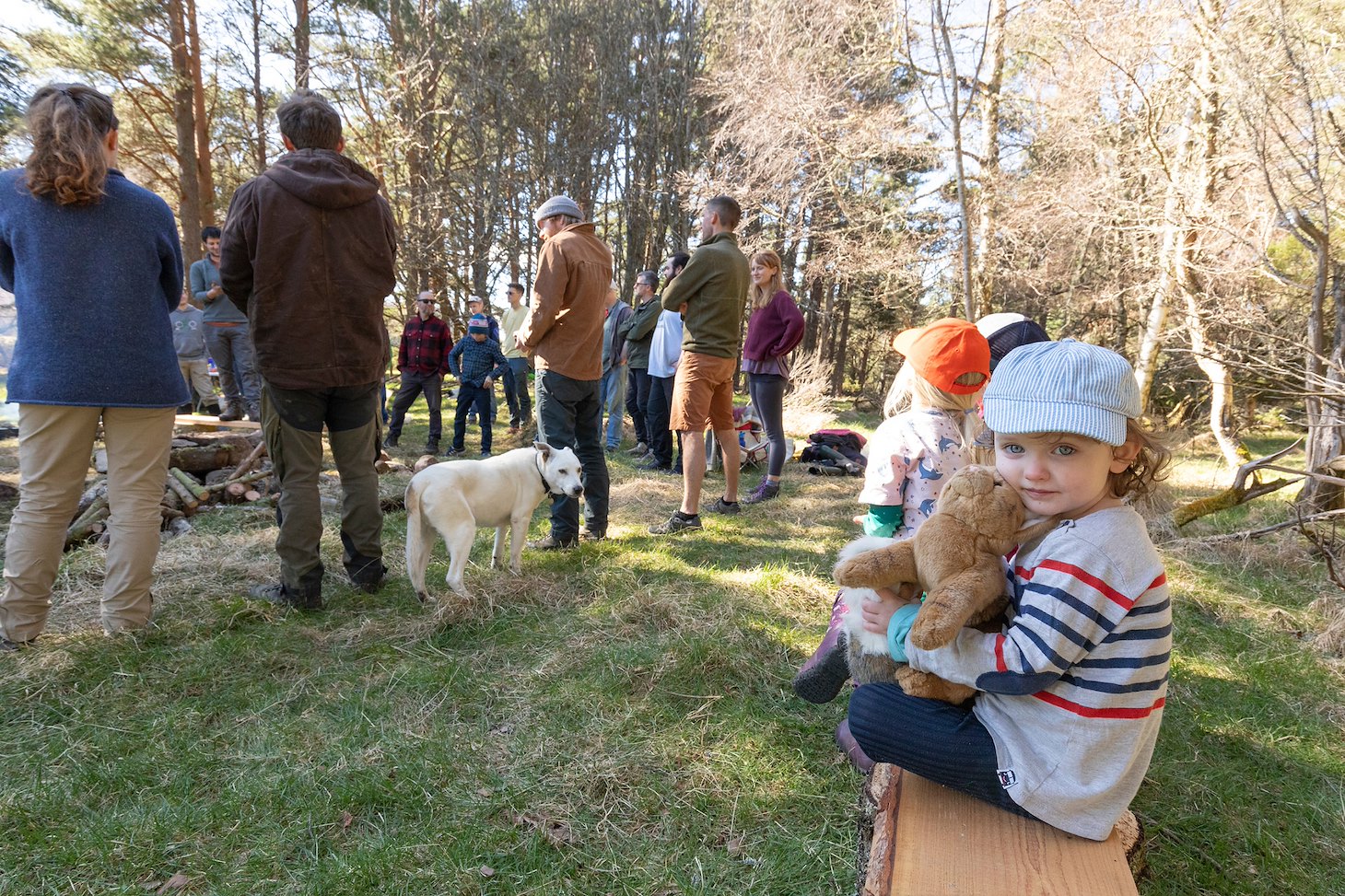 Young child on wooden bench at 'RESTORE' - a community woodland crafts and skills project at Lynamer, a Northwoods Rewilding Network land partner, Nethybridge, Cairngorms National Park, April 2023
