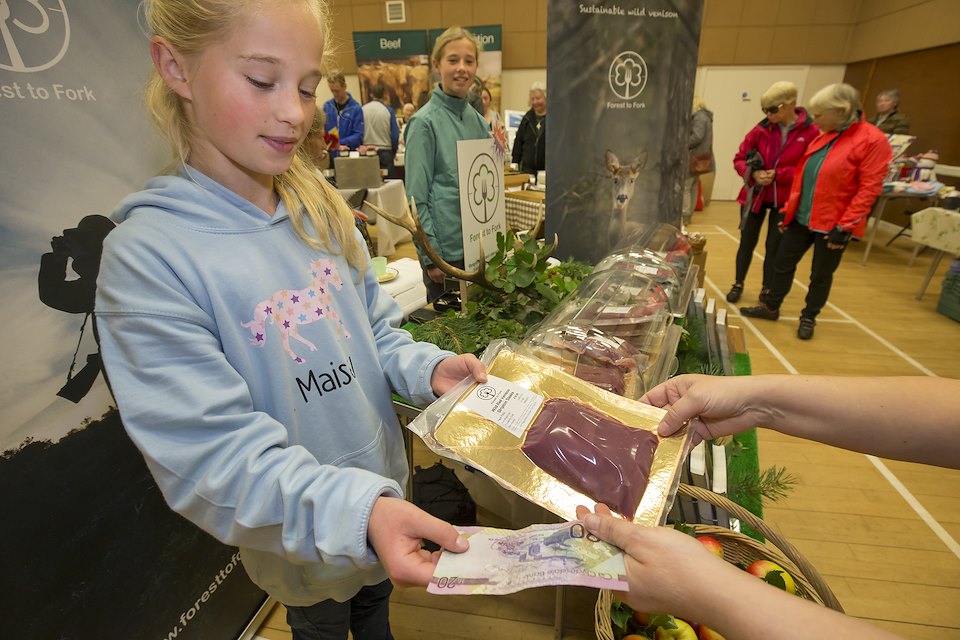 Nick Richards, owner of Forest to Fork, a supplier of wild venison in Scotland working with his family to sell wild venison at a Farmers Market in Culbokie.