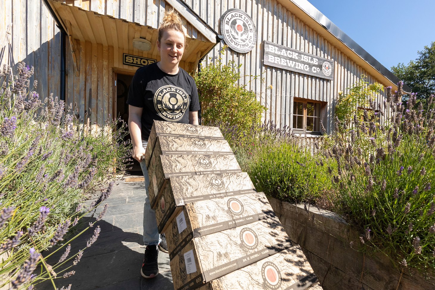 Shop retailer taking boxes of beer to customer's car, Black Isle Brewery, Munlochy