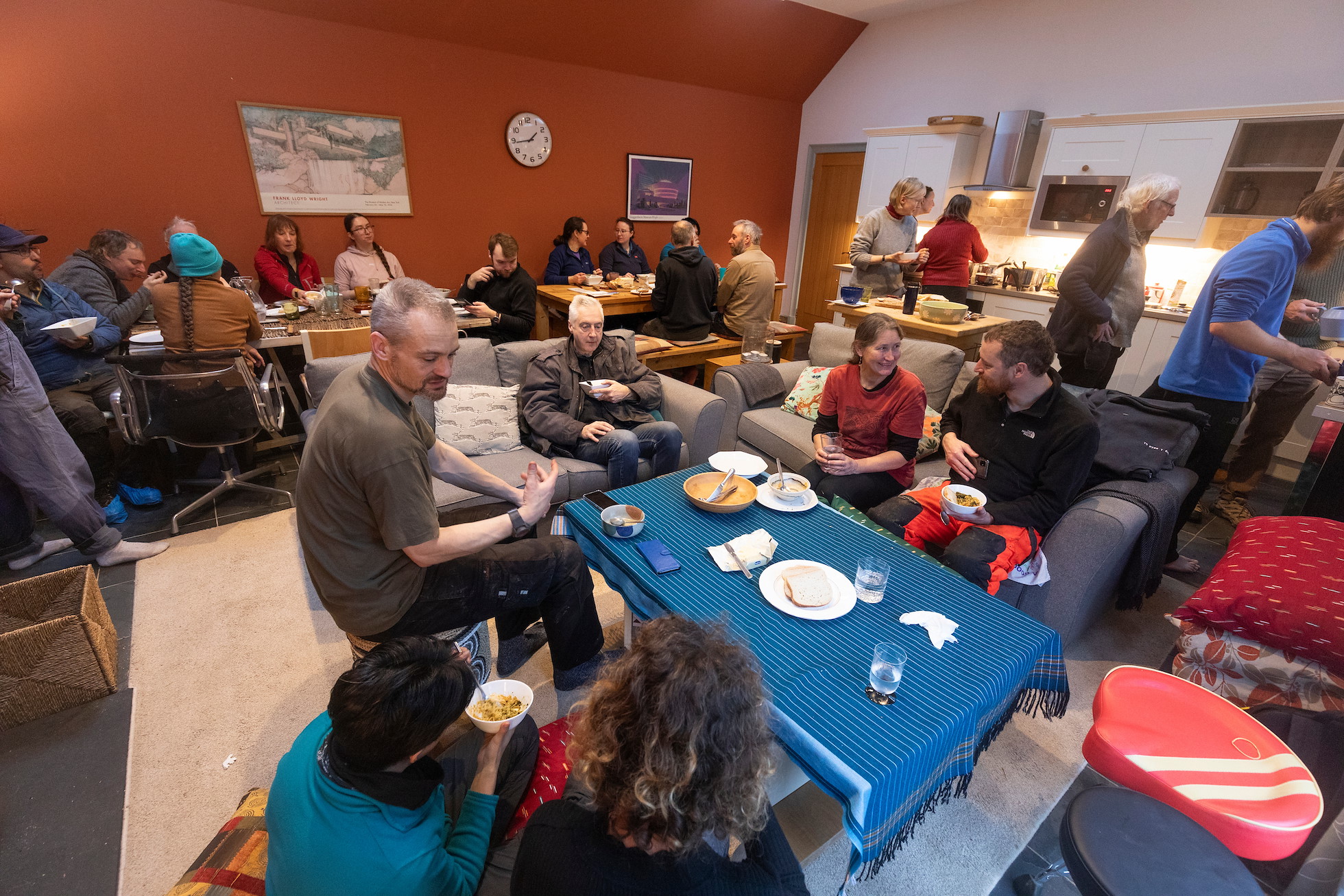 Group of people enjoying a lunchtime meal in the bothy, Sauchie Home Farm, Stirling, Scotland, December 2025